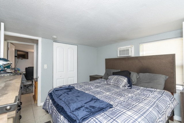 4337 Clinton Blvd, Lake Worth, FL 33461 - bedroom featuring light tile patterned floors, a closet, a textured ceiling, and a wall unit AC