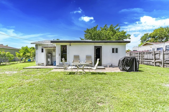 4337 Clinton Blvd, Lake Worth, FL 33461 - rear view of property featuring a fenced backyard, stucco siding, and a patio area