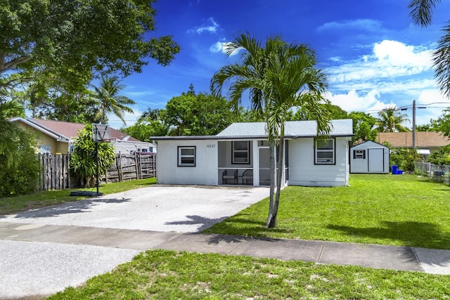 4337 Clinton Blvd, Lake Worth, FL 33461 - single story home featuring a shed and asphalt driveway