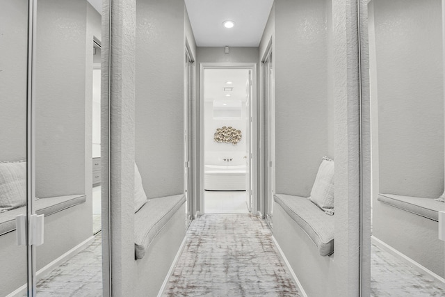 4450 SW Long Bay Dr, Palm City, FL 34990 - hallway featuring a textured wall and baseboards