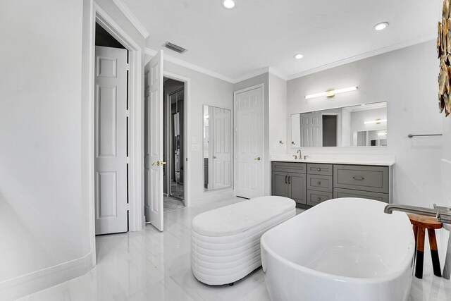 4450 SW Long Bay Dr, Palm City, FL 34990 - bathroom featuring a freestanding bath, vanity, crown molding, recessed lighting, and marble tiled floors