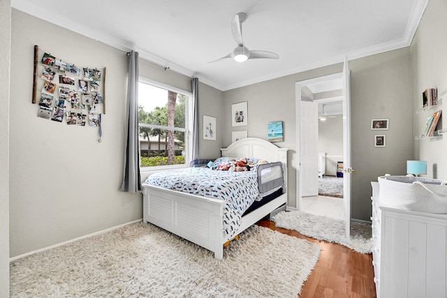 4450 SW Long Bay Dr, Palm City, FL 34990 - bedroom with crown molding, baseboards, ceiling fan, and wood finished floors