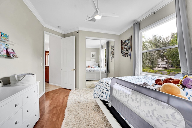 4450 SW Long Bay Dr, Palm City, FL 34990 - bedroom featuring ornamental molding, wood finished floors, a closet, baseboards, and a ceiling fan
