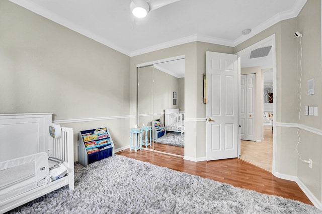 4450 SW Long Bay Dr, Palm City, FL 34990 - bedroom featuring wood finished floors, ornamental molding, baseboards, and a closet