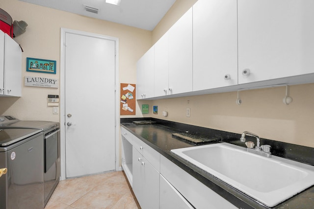 4450 SW Long Bay Dr, Palm City, FL 34990 - laundry room featuring cabinet space, washing machine and clothes dryer, and light tile patterned floors