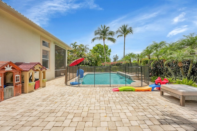 4450 SW Long Bay Dr, Palm City, FL 34990 - view of swimming pool with a sunroom and a patio area