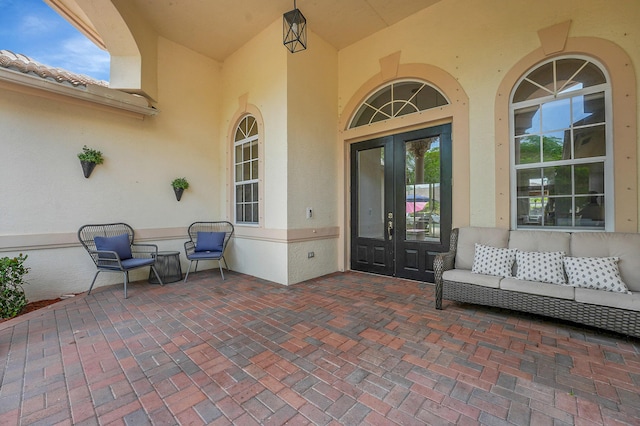 4450 SW Long Bay Dr, Palm City, FL 34990 - doorway to property featuring french doors, stucco siding, and a patio