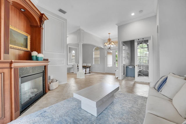 4450 SW Long Bay Dr, Palm City, FL 34990 - living area featuring a chandelier, ornamental molding, light tile patterned flooring, baseboards, and a tiled fireplace