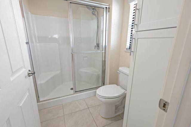 2 Tosca, Fort Pierce, FL 34951 - bathroom featuring toilet, tile patterned flooring, and a stall shower