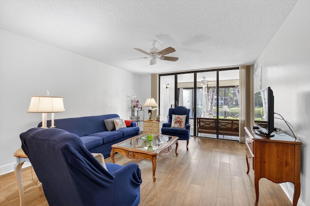 16000 Loch Katrine Trl Unit 8002, Delray Beach, FL 33446 - living area with a textured ceiling, a ceiling fan, wood finished floors, and a wall of windows