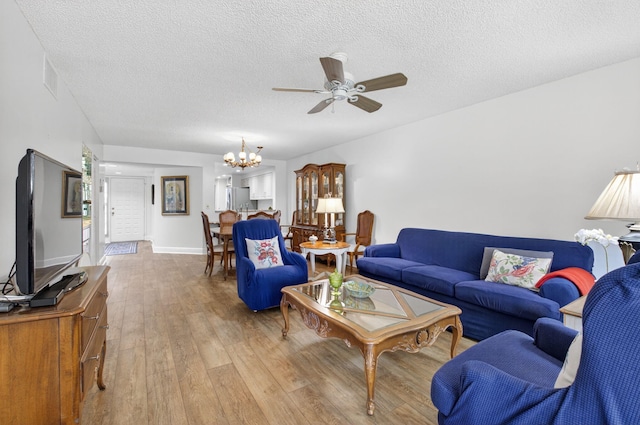 16000 Loch Katrine Trl Unit 8002, Delray Beach, FL 33446 - living room featuring light wood-style floors, a chandelier, a ceiling fan, and a textured ceiling