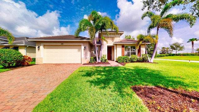 11710 SW Apple Blossom Trl, Port Saint Lucie, FL 34987 - view of front facade with decorative driveway, an attached garage, stucco siding, and a front lawn