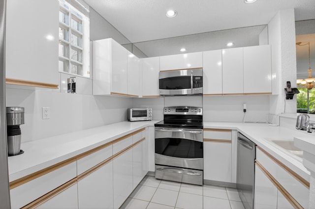 20220 Boca W Dr Unit 1104, Boca Raton, FL 33434 - kitchen with appliances with stainless steel finishes, white cabinets, recessed lighting, and light countertops