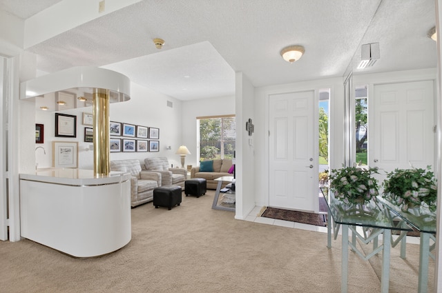20220 Boca W Dr Unit 1104, Boca Raton, FL 33434 - living area featuring light carpet, a textured ceiling, and a textured wall