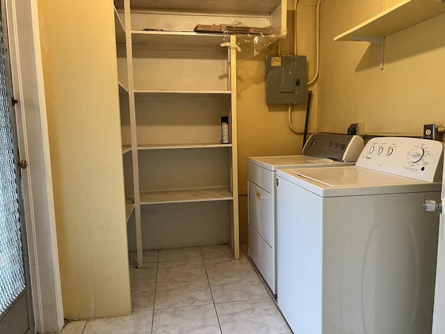 5042 Eadie Pl, West Palm Beach, FL 33407 - laundry room featuring electric panel, washing machine and clothes dryer, and light marble finish flooring
