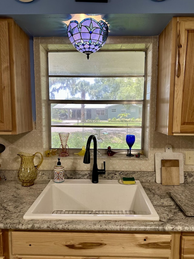 3595 SW 19th St, Okeechobee, FL 34974 - kitchen with a sink, decorative backsplash, light countertops, and light brown cabinets