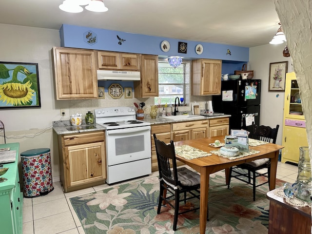3595 SW 19th St, Okeechobee, FL 34974 - kitchen featuring electric stove, under cabinet range hood, a sink, freestanding refrigerator, and light tile patterned floors