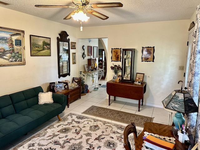 3595 SW 19th St, Okeechobee, FL 34974 - living room featuring a ceiling fan, a textured ceiling, light tile patterned floors, and arched walkways