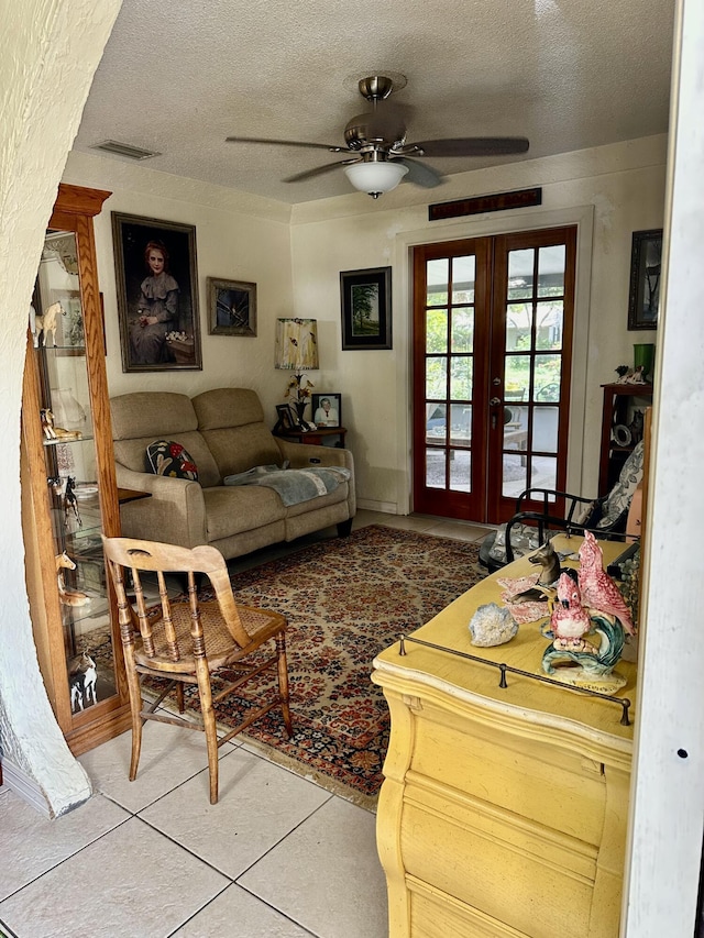 3595 SW 19th St, Okeechobee, FL 34974 - tiled living area featuring a ceiling fan, french doors, and a textured ceiling