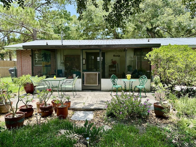 3595 SW 19th St, Okeechobee, FL 34974 - back of property featuring a patio area, metal roof, and brick siding