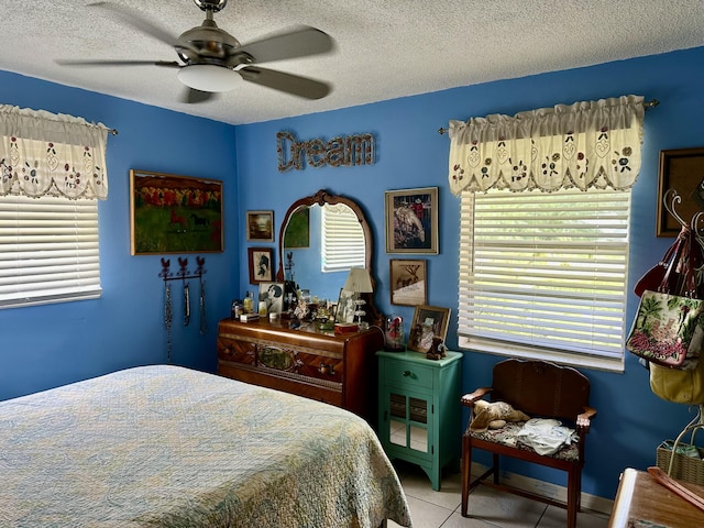 3595 SW 19th St, Okeechobee, FL 34974 - bedroom with light tile patterned floors, a textured ceiling, and a ceiling fan
