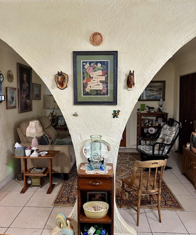 3595 SW 19th St, Okeechobee, FL 34974 - living area featuring tile patterned floors, a textured wall, and baseboards