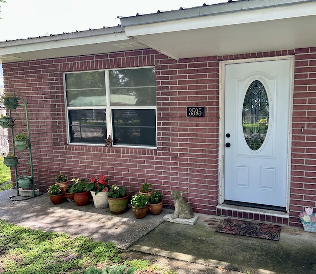 3595 SW 19th St, Okeechobee, FL 34974 - property entrance featuring brick siding and metal roof