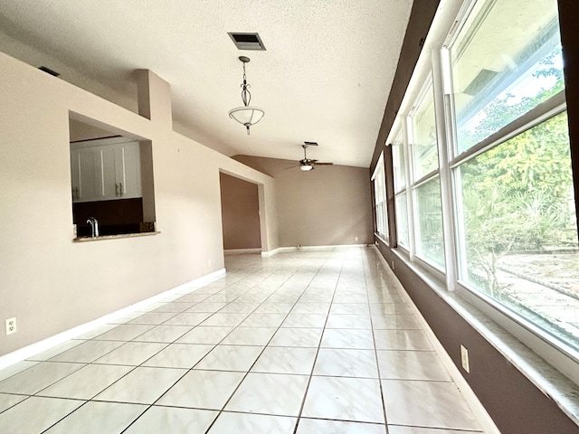 6404 Moonstone Way, Delray Beach, FL 33484 - spare room featuring a ceiling fan, a textured ceiling, and vaulted ceiling