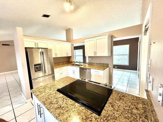 6404 Moonstone Way, Delray Beach, FL 33484 - kitchen with appliances with stainless steel finishes, light tile patterned floors, a textured ceiling, white cabinetry, and light stone countertops