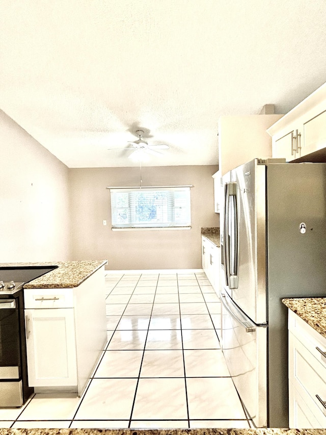 6404 Moonstone Way, Delray Beach, FL 33484 - kitchen with stainless steel appliances, white cabinets, a ceiling fan, light stone counters, and a textured ceiling