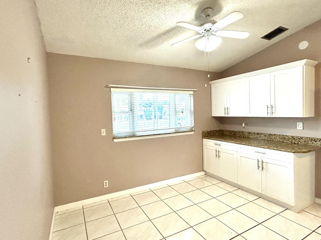 6404 Moonstone Way, Delray Beach, FL 33484 - kitchen with a ceiling fan, dark countertops, white cabinetry, lofted ceiling, and a textured ceiling