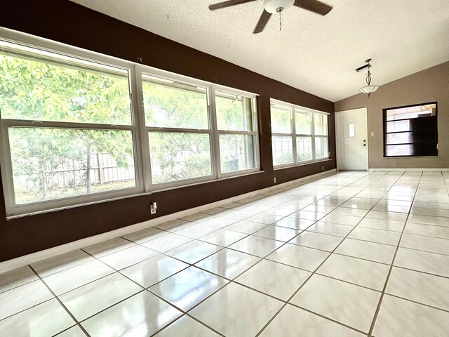 6404 Moonstone Way, Delray Beach, FL 33484 - spare room with ceiling fan, lofted ceiling, light tile patterned flooring, and a textured ceiling