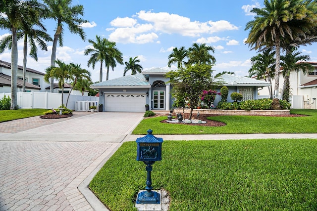 1680 SW 16th St, Boca Raton, FL 33486 - view of front of property featuring decorative driveway, an attached garage, french doors, stucco siding, and a tile roof