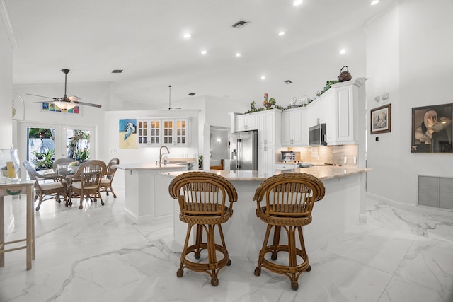 1680 SW 16th St, Boca Raton, FL 33486 - kitchen featuring appliances with stainless steel finishes, light marble finish floors, a ceiling fan, recessed lighting, and a peninsula
