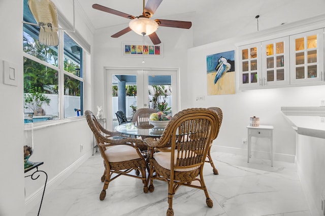 1680 SW 16th St, Boca Raton, FL 33486 - dining room featuring light marble finish floors, french doors, plenty of natural light, ceiling fan, and ornamental molding