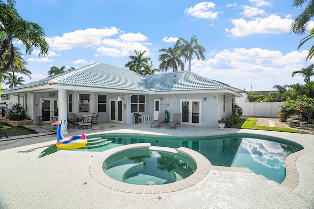 1680 SW 16th St, Boca Raton, FL 33486 - view of pool with french doors, a patio area, and a pool with connected hot tub