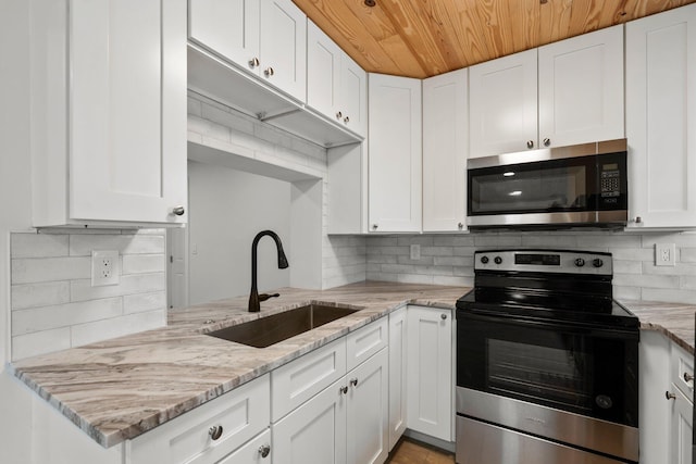 677 NE Alice St, Jensen Beach, FL 34957 - kitchen featuring appliances with stainless steel finishes, a sink, tasteful backsplash, and wood ceiling