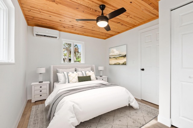 677 NE Alice St, Jensen Beach, FL 34957 - bedroom with wooden ceiling, a wall mounted air conditioner, light wood-style flooring, and ceiling fan