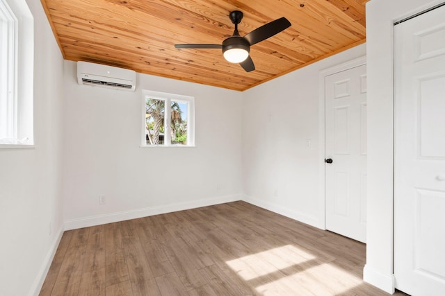 677 NE Alice St, Jensen Beach, FL 34957 - spare room featuring wooden ceiling, a wall mounted air conditioner, ceiling fan, wood finished floors, and baseboards