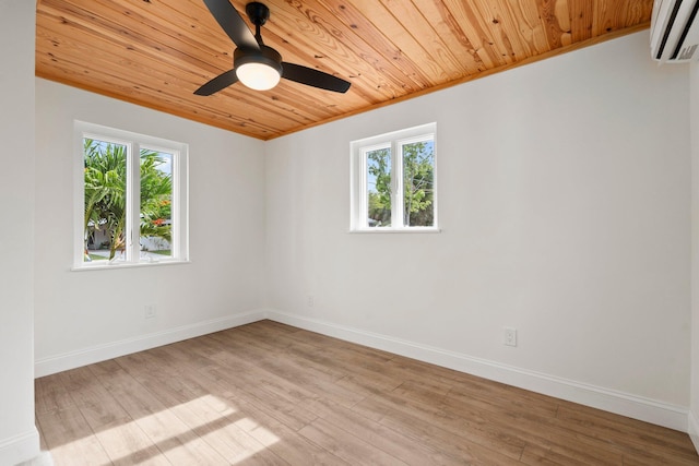 677 NE Alice St, Jensen Beach, FL 34957 - empty room featuring wooden ceiling, an AC wall unit, plenty of natural light, baseboards, and wood finished floors