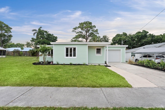 677 NE Alice St, Jensen Beach, FL 34957 - view of front of home featuring driveway and a garage