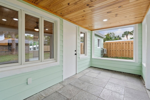 677 NE Alice St, Jensen Beach, FL 34957 - unfurnished sunroom with plenty of natural light and cooling unit