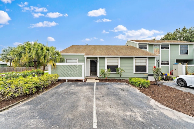 202 Lakewood Dr Unit 11C, Jupiter, FL 33458 - view of front of house with uncovered parking and a shingled roof