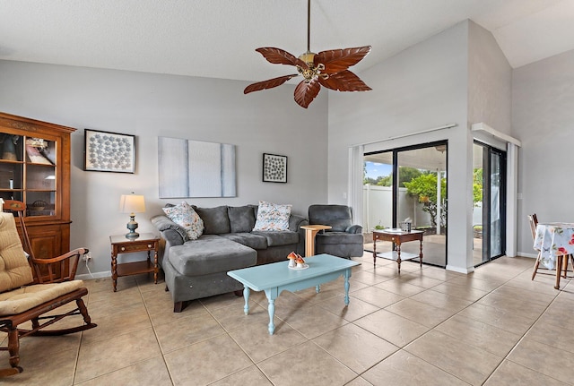202 Lakewood Dr Unit 11C, Jupiter, FL 33458 - living room featuring high vaulted ceiling, light tile patterned floors, a ceiling fan, and baseboards