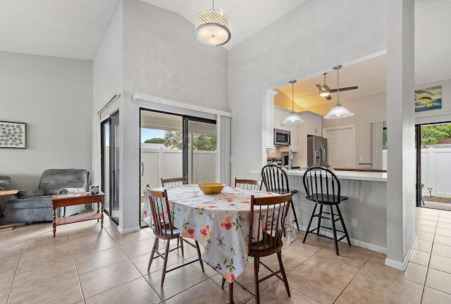 202 Lakewood Dr Unit 11C, Jupiter, FL 33458 - dining area with high vaulted ceiling, light tile patterned floors, and baseboards