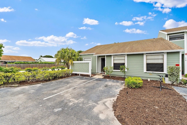 202 Lakewood Dr Unit 11C, Jupiter, FL 33458 - view of front facade featuring uncovered parking and roof with shingles