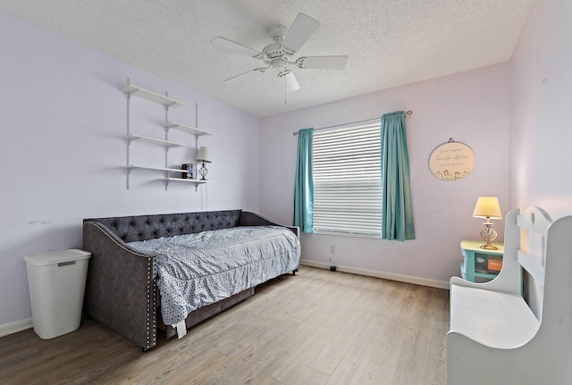 202 Lakewood Dr Unit 11C, Jupiter, FL 33458 - bedroom featuring wood finished floors, baseboards, a textured ceiling, and ceiling fan
