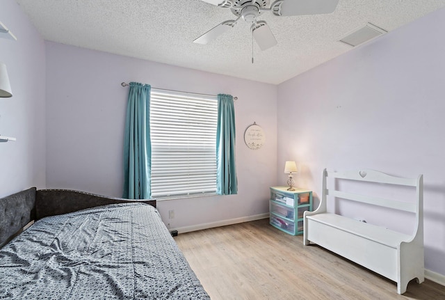 202 Lakewood Dr Unit 11C, Jupiter, FL 33458 - bedroom with wood finished floors, a textured ceiling, ceiling fan, and baseboards