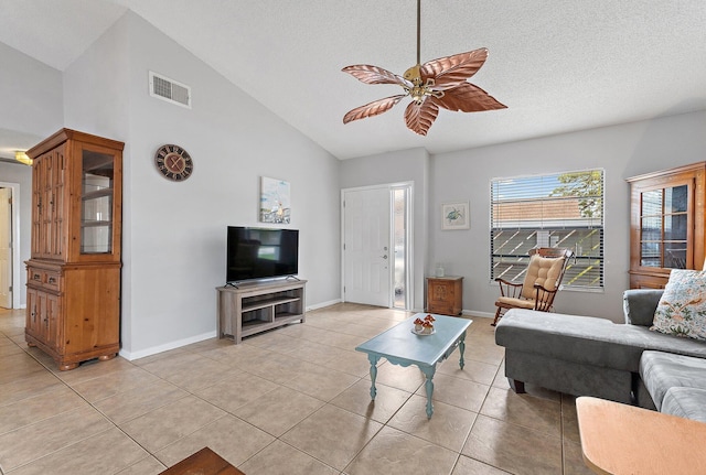 202 Lakewood Dr Unit 11C, Jupiter, FL 33458 - living area with light tile patterned floors, a ceiling fan, baseboards, a textured ceiling, and high vaulted ceiling