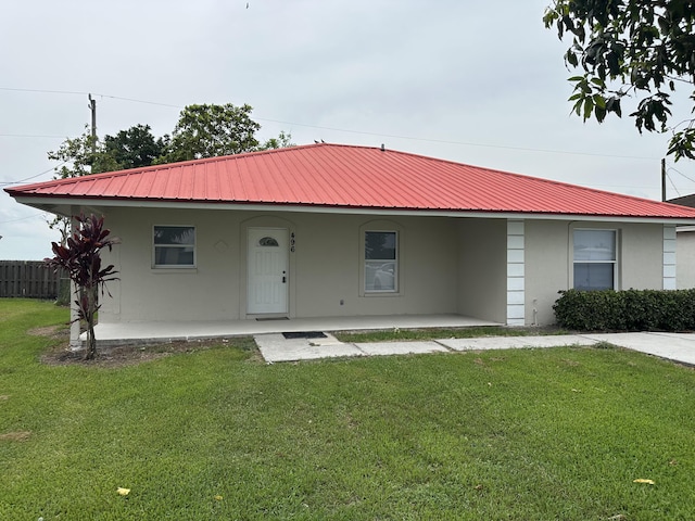 496 E Jordan Blvd, Pahokee, FL 33476 - view of front of property featuring stucco siding, metal roof, and covered porch